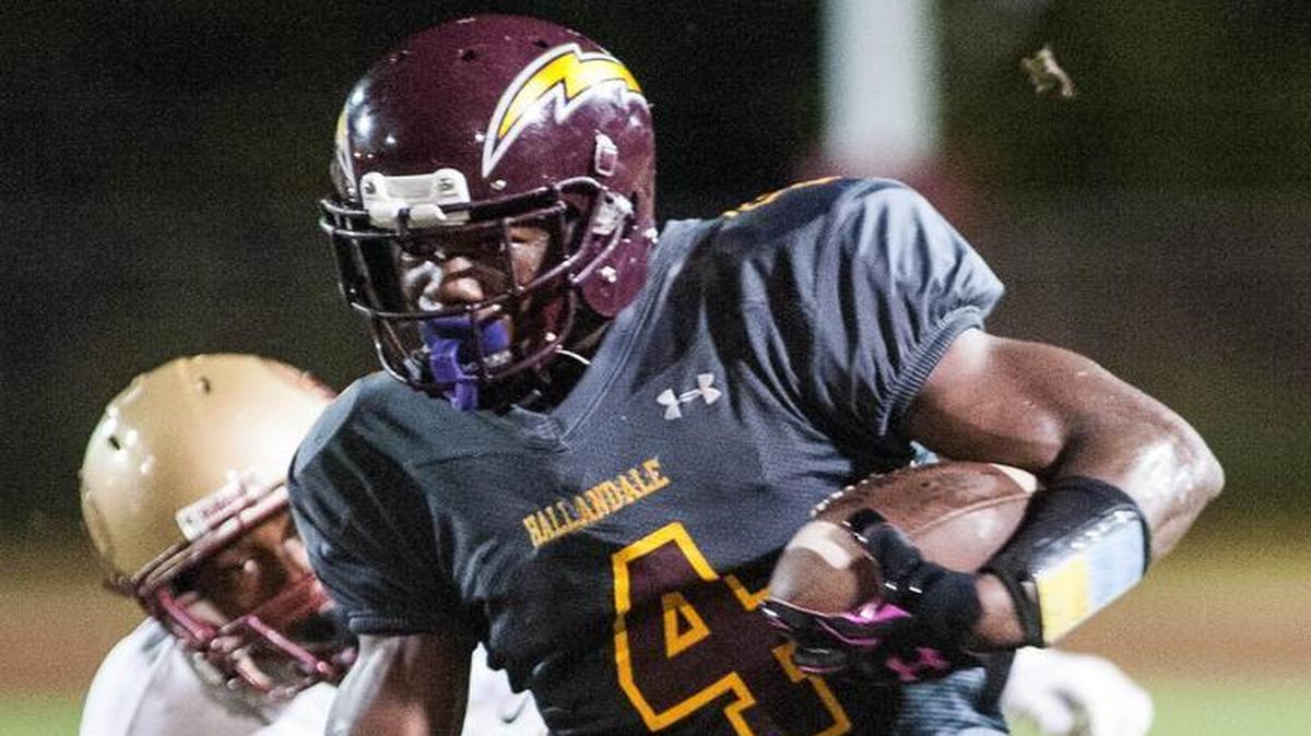 Hallandale’s Zach Moss tries to break a tackle during the second quarter of a high school football game against Coconut Creek on Friday, Oct. 9, 2015.