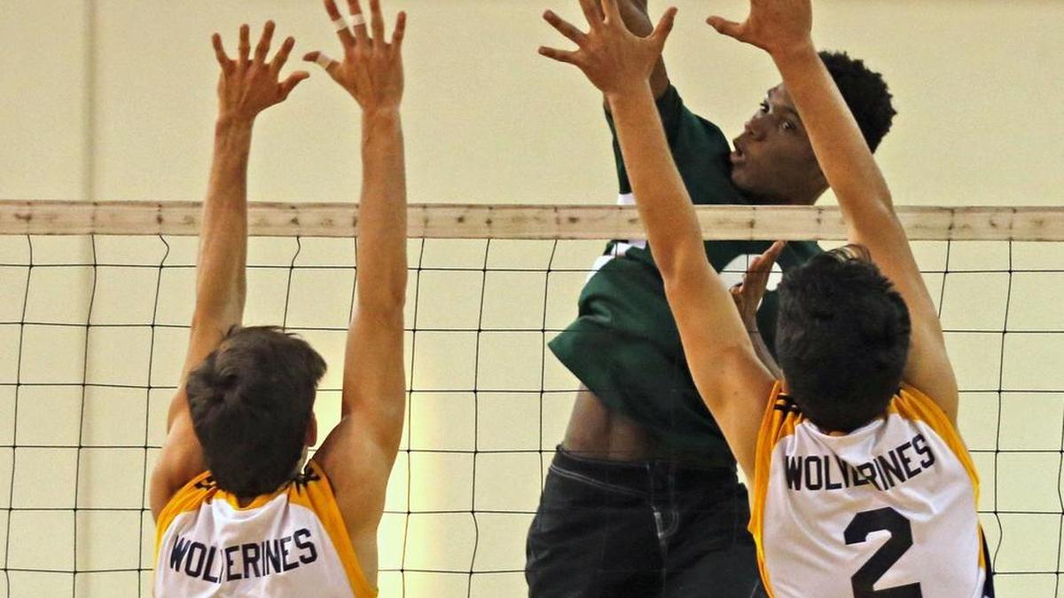 Killian’s Jomar Mondestin beats Belen’s Lucas Osorio (5) and Alejandro Guerrero (2) in a play-in match Tuesday.
