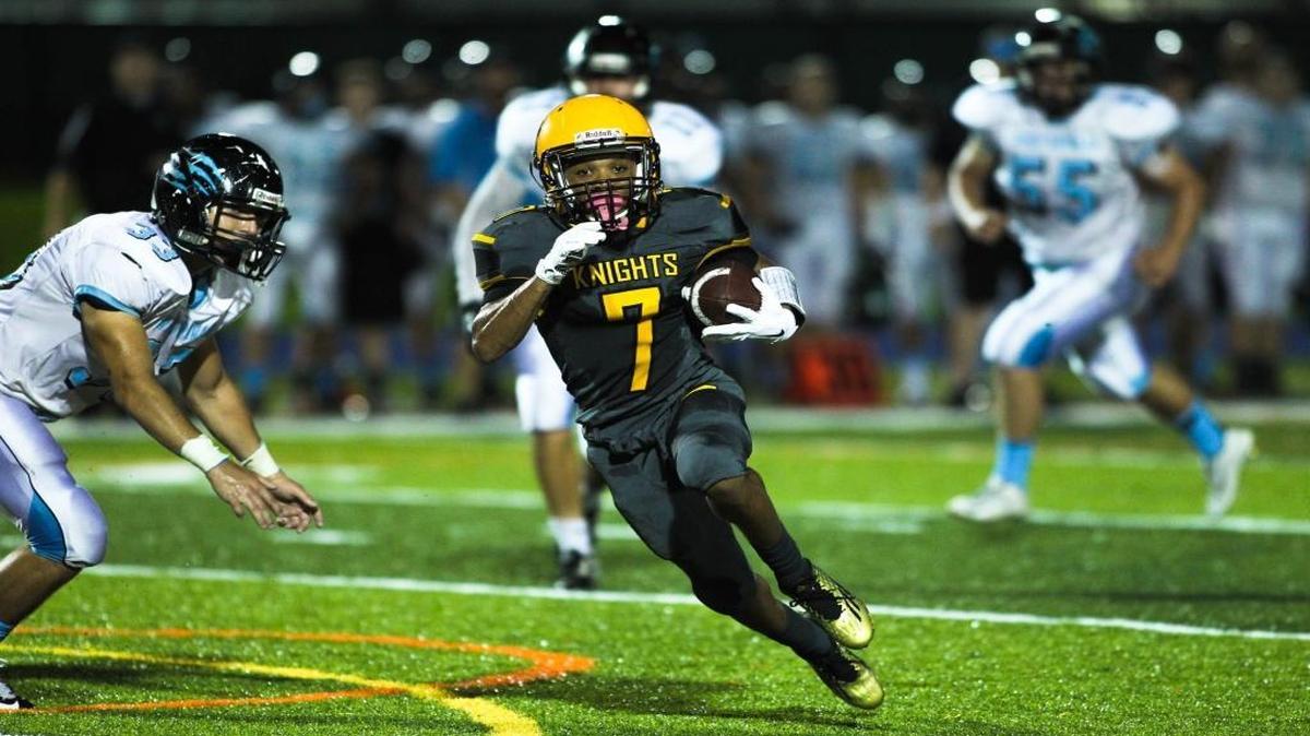 Sunset Knights' Tariq Peters, No. 7, runs with the ball as the Knights play against the West Broward Bob Cats on Friday, Nov. 13, at Tropical Park in Miami.