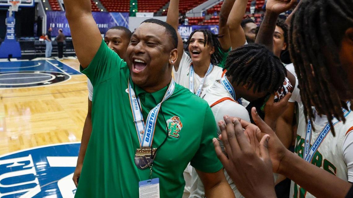 Blanche Ely Tigers’ head coach J.R. McNabb raises the championship trophy after defeating Ponte Vedra in the Class 5A state boys’ basketball championship at the RP Funding Center in Lakeland, Florida on Friday, March 7, 2025.