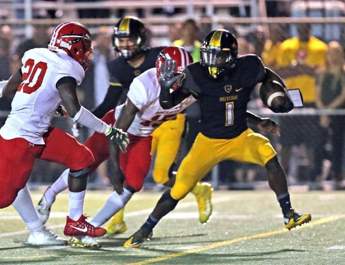 American Heritage’s Miles Jones (1) runs the ball as they play Immokalee at American Heritage High School on Dec. 1, 2017.