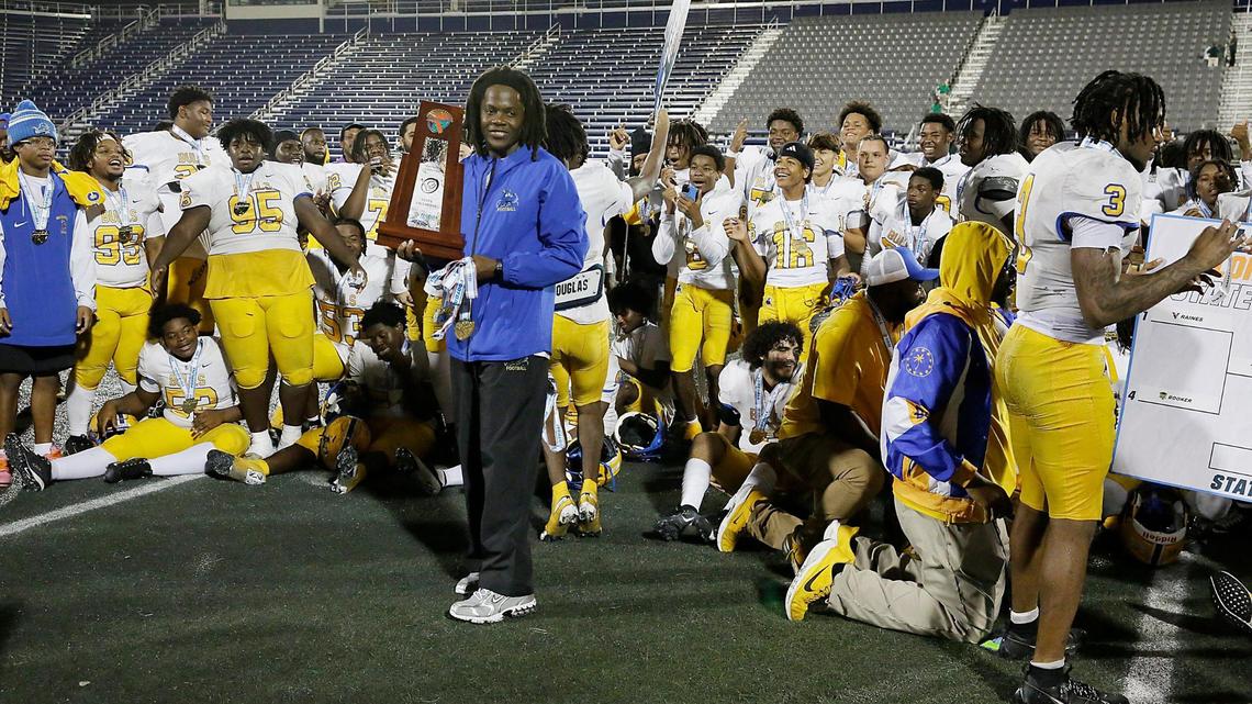 Northwestern Bulls head coach Teddy Bridgewater holds the state championship trophy after his team won the Class 3A state final against the Jacksonville Raines Vikings on Saturday, December 14, 2024 at Pitbull Stadium in Miami.