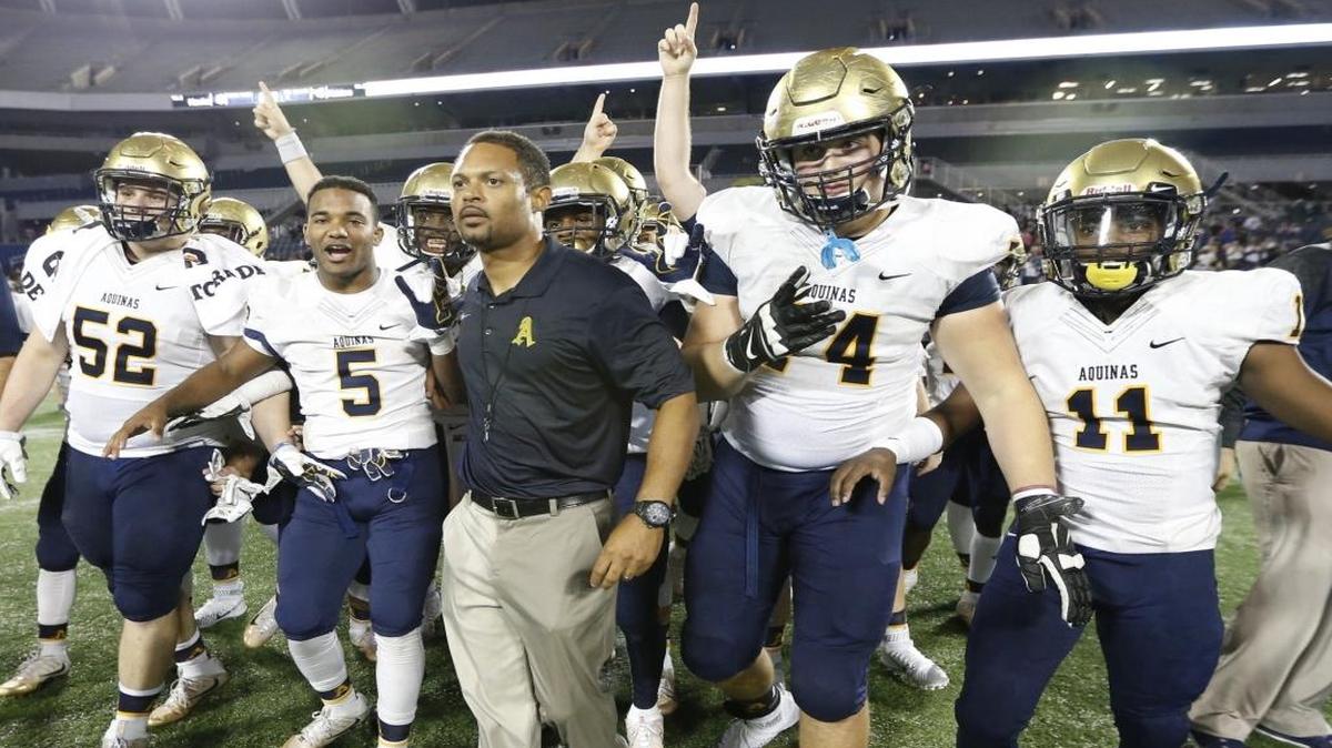 St. Thomas Aquinas coach Roger Harriott celebrates with his team after defeating Viera 45-10 in the Class 7A championship at Citrus Bowl in Orlando on Friday, December 11, 2015.