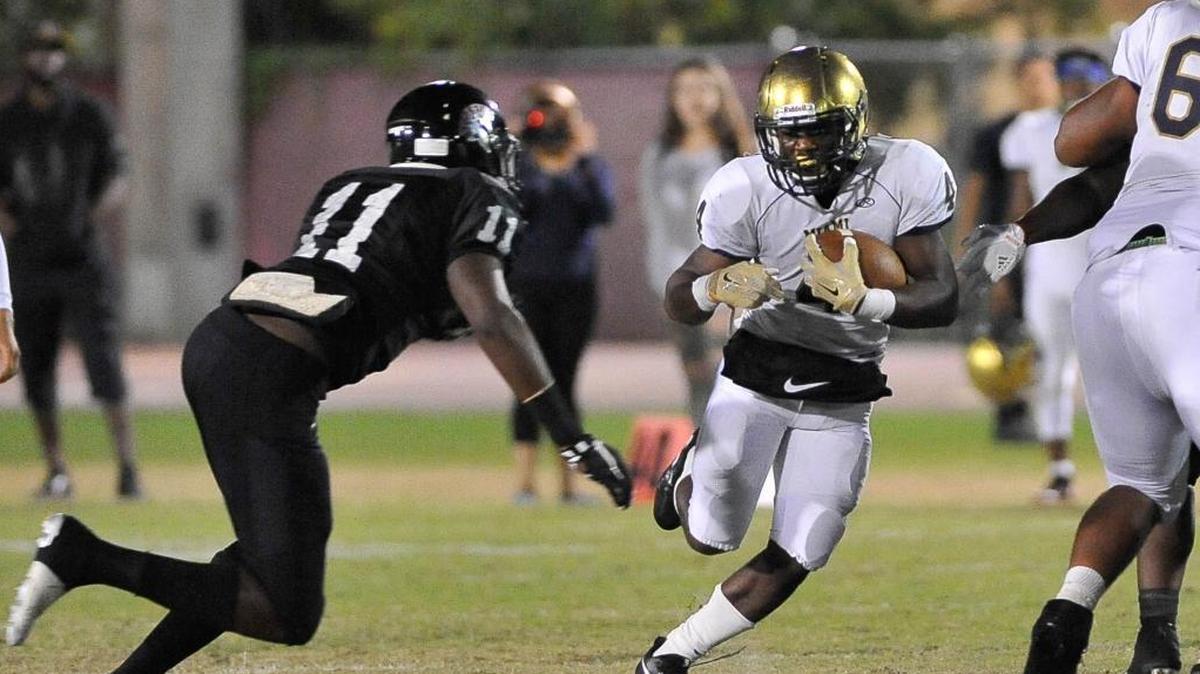 Miami high running back Marcus Barthell tries to get past Southridge James Head during the first half of a high school playoff football game in Miami, Fla. Friday Nov. 17, 2017.
