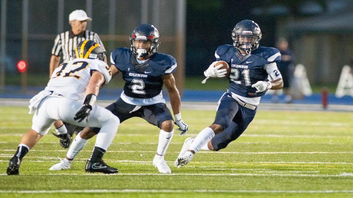 Columbus high Henry Parrish Jr.breaks a tackle during a football game against the Belen Jesuit Wolverines, Friday night in Miami.