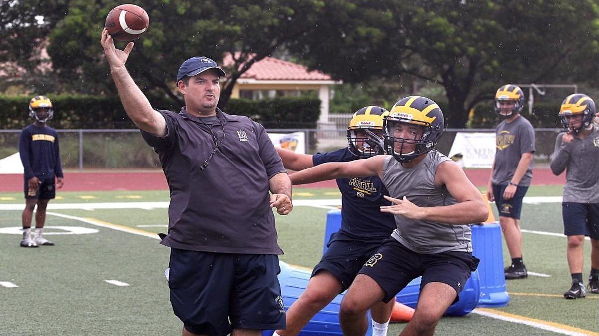 Belen’s head football coach Ed Delgado, left, conducts drill during the first day of practice for upcoming fall football season at Belen Preparatory School in Miami on Monday, July 31, 2017.