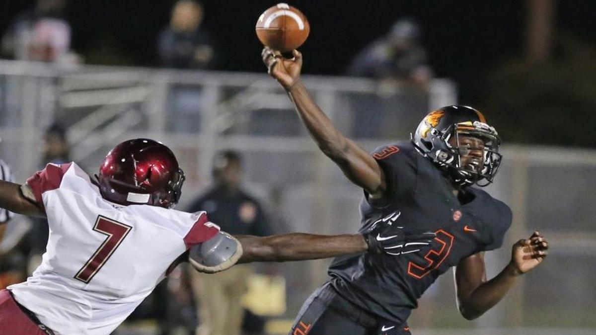 
Eric Walker passes as Booker T. Washington hosts Citra North Marion at Traz Powell Stadium in a preseason game Friday, Aug. 21, 2015.
