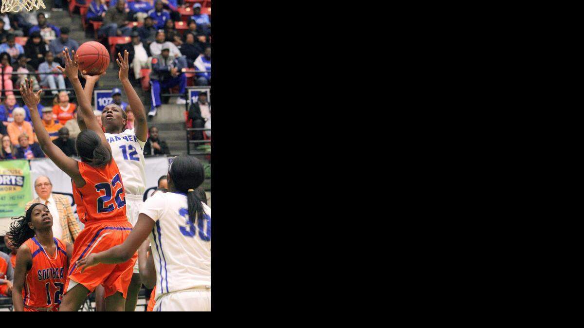 
Fort Lauderdale Dillard’s Jacaira Allen goes up for a basket as Bradenton Southeast’s Mirline Valcin defends during the FHSAA Class 5A girls’ basketball semifinals at The Lakeland Center on Friday, Feb. 20, 2015 in Lakeland. 
