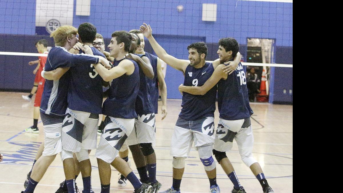 
Mourning High volleyball players celebrate a victory against South Broward on Tuesday, May 5, 2015 at Alonzo and Tracy Mourning HS in North Miami.
