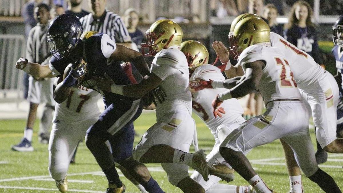 Monsignor Pace Spartans' defenders try to stop University School Sharks' Kenneth Mcintosh (1) during the football game on Friday, Nov., 17, 2017 at AutoNation Field at Nova University School in Fort Lauderdale.