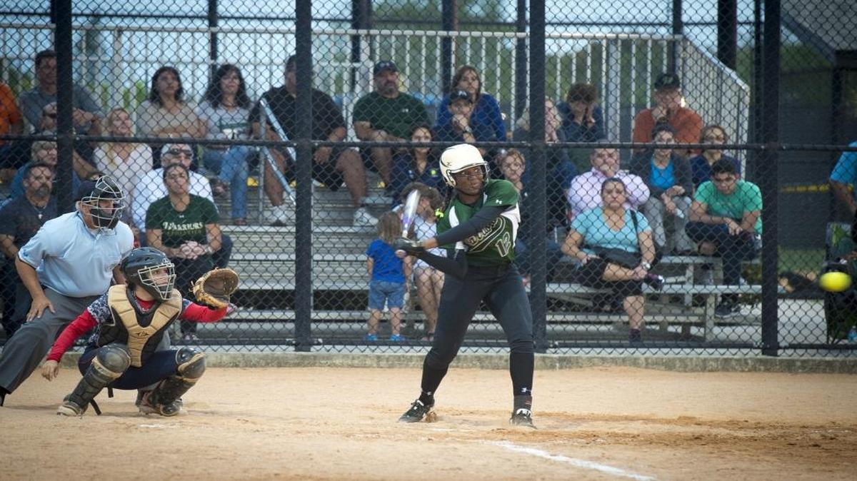 Westminster's Nikkia Benitez swings and hits a home run, the second home run early in the game as Westminster Christian takes on Chaminade-Madonna in a regional softball game at Palmetto Bay Park in Palmetto Bay on Thurs., April 21, 2016.