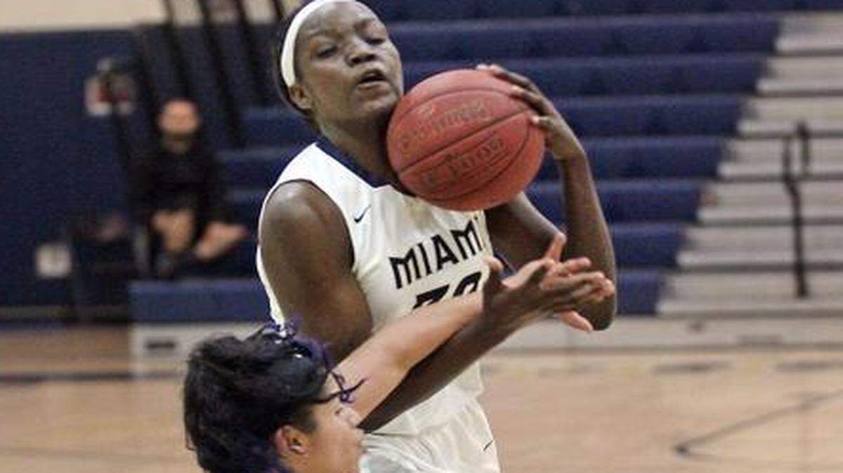 Miami High’s Beatrice Mompremier drives to the basket as Flanagan’s Jennifer Oramas holds her position during a girls’ regional semifinal game at Miami High on Tuesday, Feb. 10, 2015.
