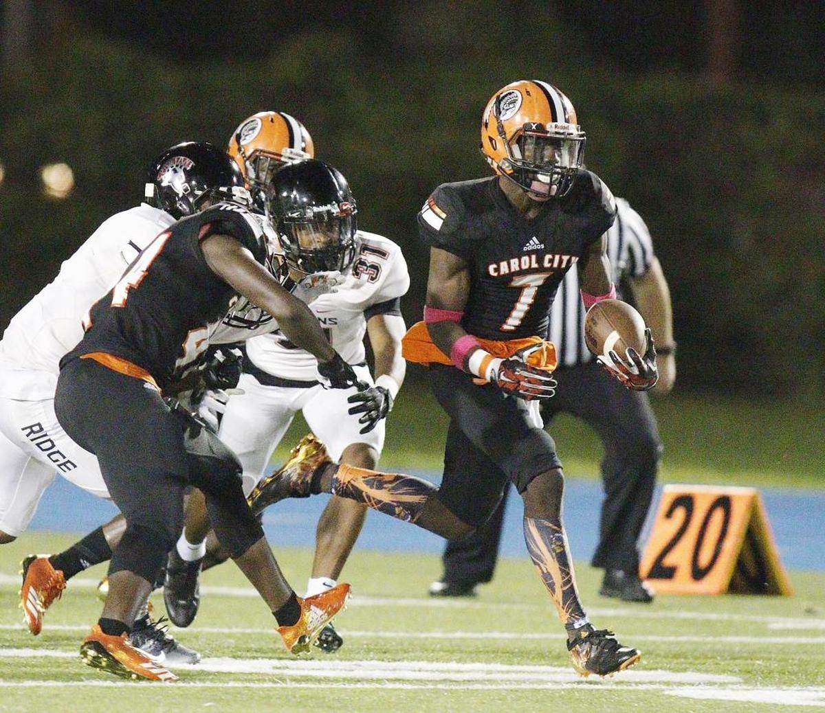 Carol City Chiefs' Gregory Grate (7) carries a ball against Southridge Spartans during the football game Fri., Oct. 6, 2017 at Traz Powell stadium.