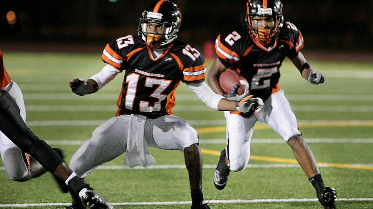 Benedick Hyppolite, left, played for Booker T. Washington’s state title team in 2007. Now, he is the head coach at defending state champion Carol City.