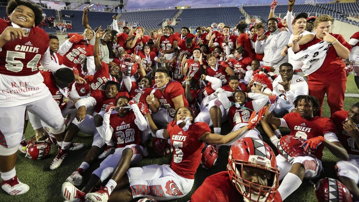 The Cardinal Gibbons team celebrates after defeating North Marion in the Florida High School Athletic Association State Chapionships Class 5A at Camping World Stadium in Orlando on Friday, December 7, 2018.