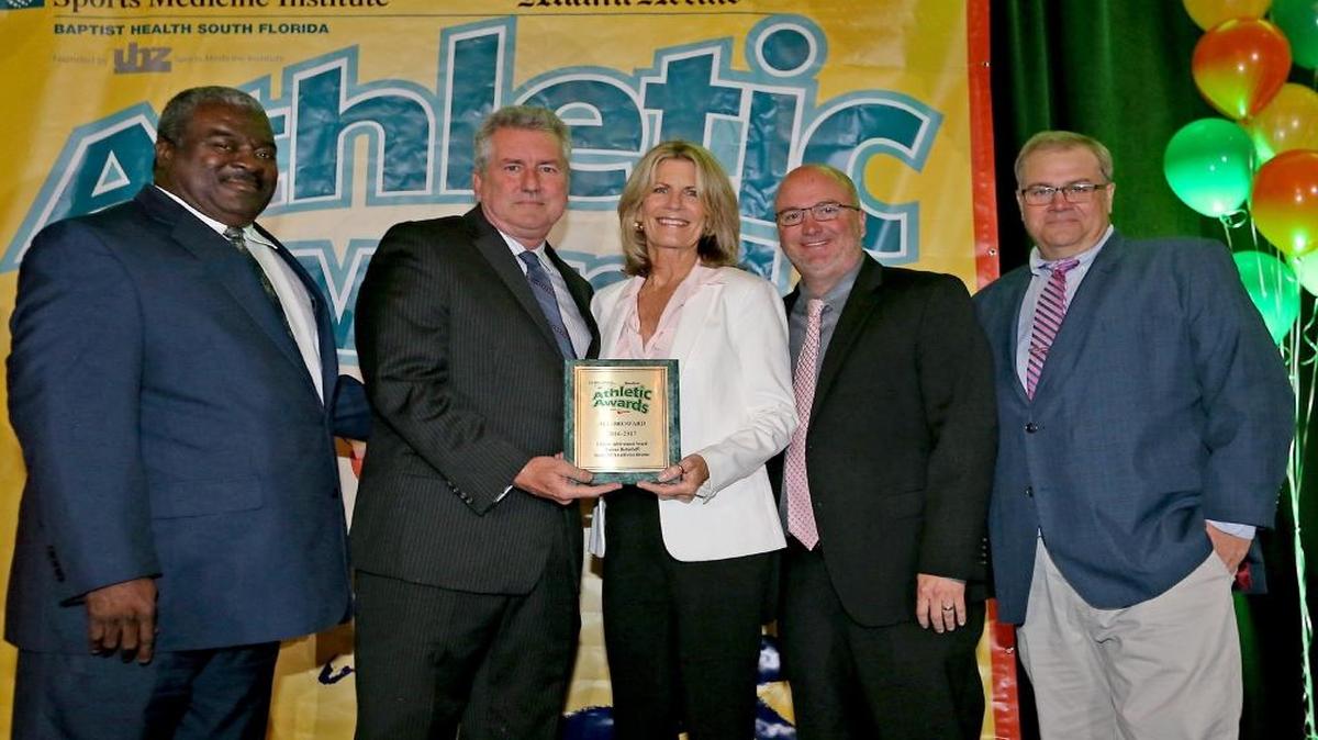 The Miami Herald's Lifetime Achievement Award in Honor of Damian Huttenhoff was presented to Donna Huttenhoff (center) by Herald Sportswriter Bill Daley, alongside Rocky Gillis (left) and Herald Sportswriter George Richards (right) at the Miami Herald Broward Athletic Awards banquet at Signature Gardens in Davie on Thurs., May 25, 2017.