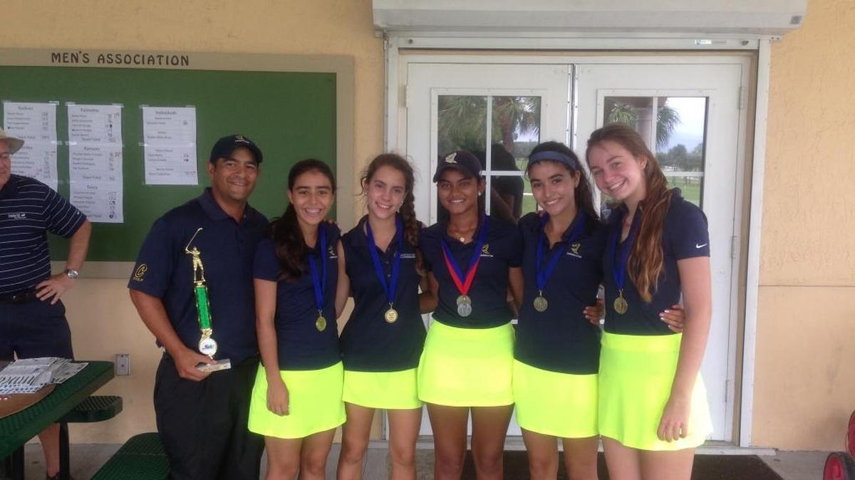 
From left to right, Carrollton girls’ golf team coach Armando Echevarria (holding the trophy) is joined by golfers Andy Delgado, Irene Labarta, Tanya Eathakotti, Gaby Delgado and Charlotte Stott.
