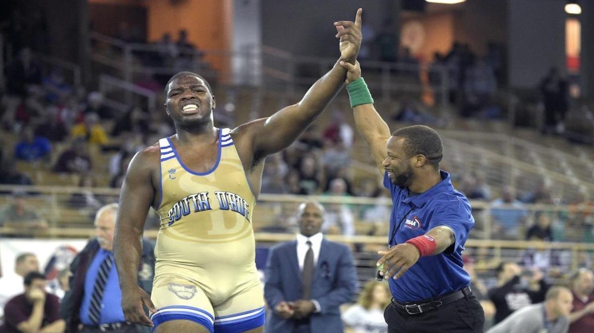 Miami South Dade's Kyron Taylor, left, celebrates after defeating Columbus' Kyle Mann during the finals of the Class 3A FHSAA State Wrestling Championships in Kissimmee, Fla., Sat., March 5, 2016.