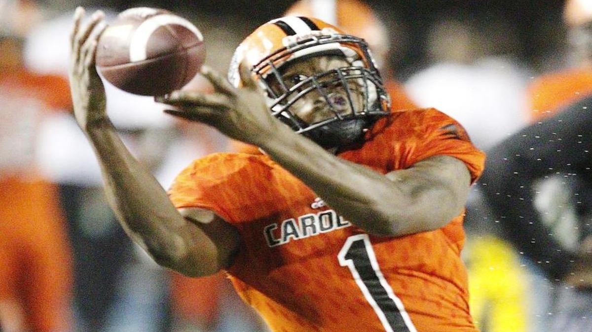 Carol City receiver Kevaughn Dingle attempts to catch a pass during a game against Northwestern on Oct. 29, 2016. On Nov. 3, 2016, Dingle caught a 35-yard touchdown pass in a 45-0 victory over American.