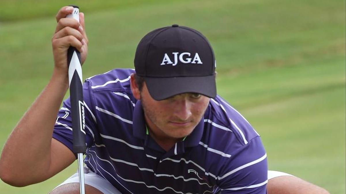 Senior Jordan Laklak of Palmetto places his ball at putting practice during a rain delay Tuesday at the Youth Fair Golf Invitational, which he won by shooting a 34 through nine holes. Inclement weather caused the tournament to be called off halfway through.