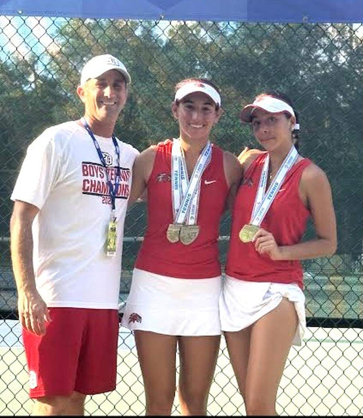 Doral Academy tennis coach Justin Puppo at state with standouts Payton Seidle-Lubowitz and Stefany Zamora.