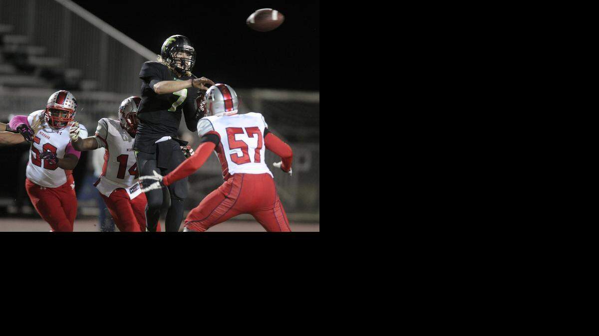 
Flanagan quarterback Ryan Stanley passes the ball while surrounded by Miramar defenders during the first half, Friday, Oct. 17, 2014.

