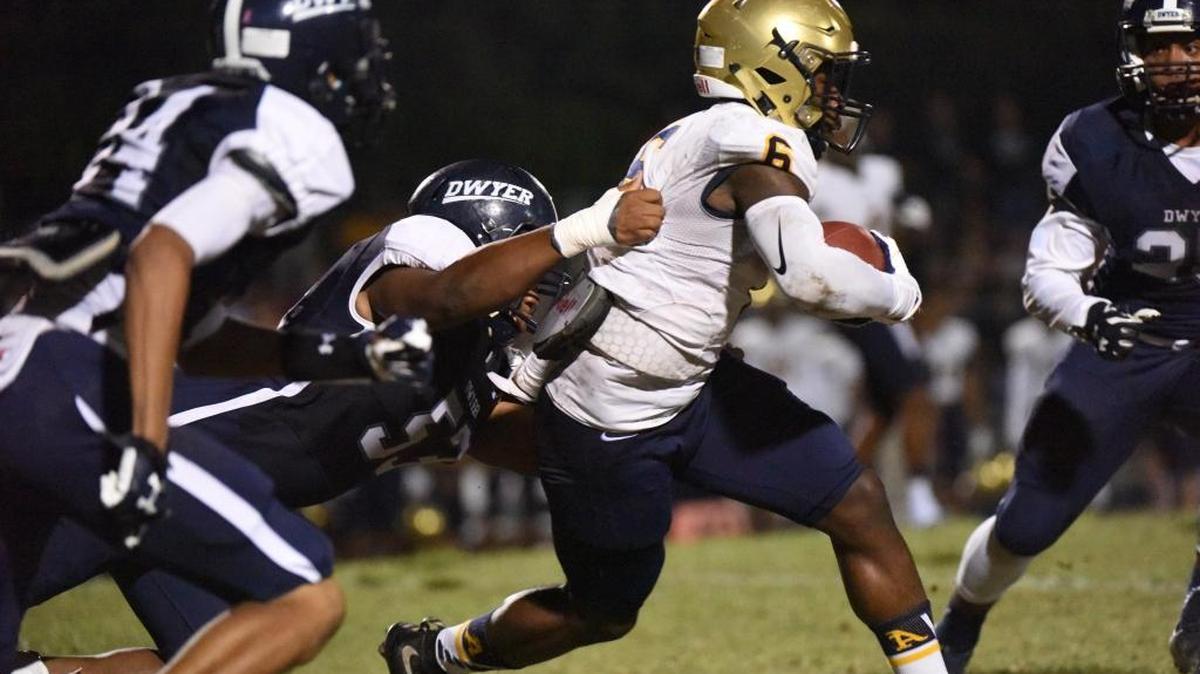 Sam Bruce of St. Thomas Aquinas gains tough yards against Palm Beach Dwyer during a Class 7A regional semifinal Friday, Nov. 20, 2015 in Palm Beach Gardens.