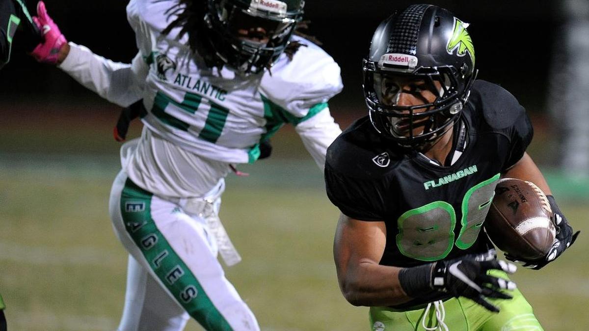 Flanagan’s Jahcour Pearson runs past Atlantic’s Datrone Young during the first half Friday, Nov. 27, 2015.