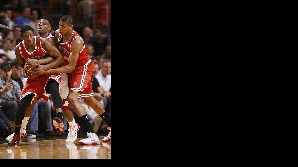 Brandon Knight tries to secure the ball in the second quarter as he is challenged by Norris Cole while the Miami Heat play the Milwaukee Bucks  at the American Airlines Arena  in Miami, Fl.