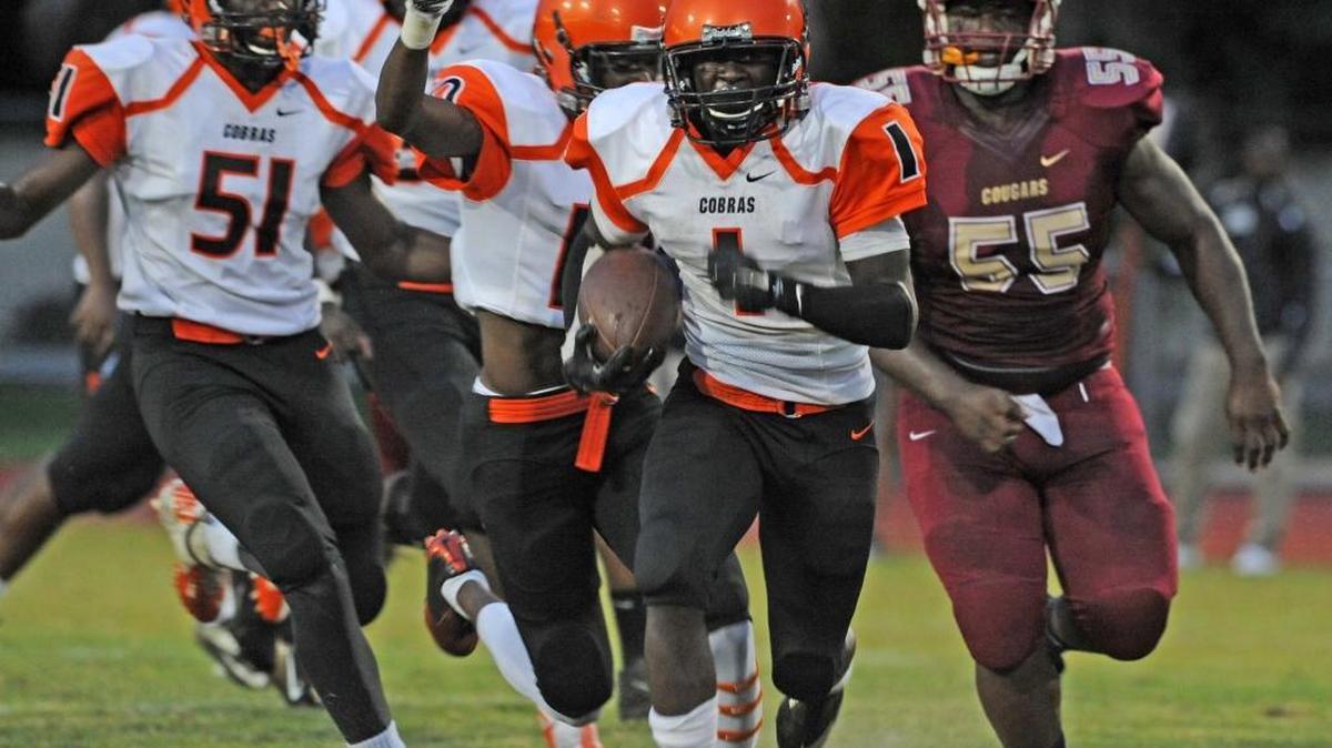 
Boyd Anderson’s Deonta Nelson takes the ball for a long run but it wasn’t enough against host Coconut Creek on Friday, Sept. 11, 2015. 
