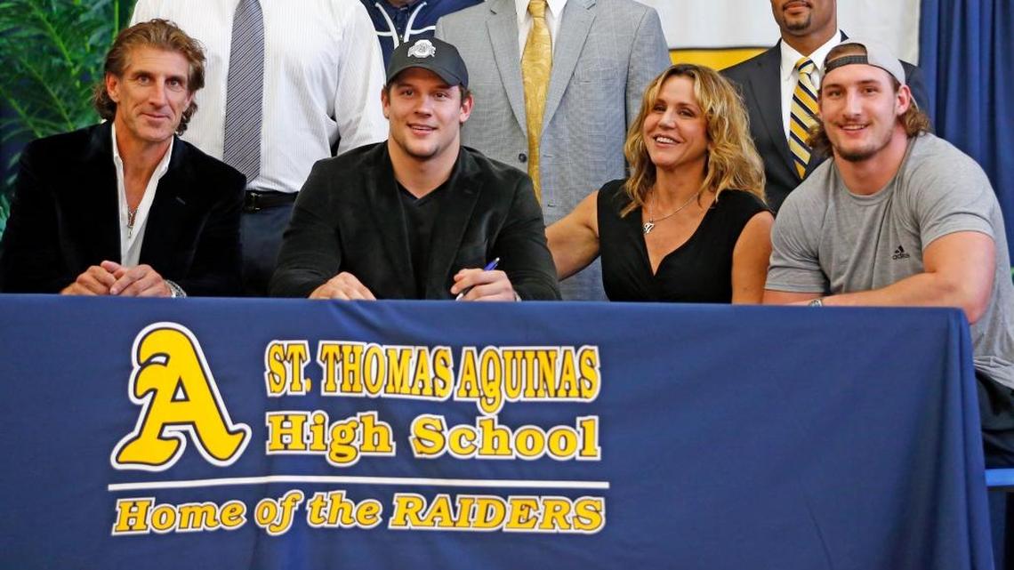 Nick Bosa, second from left, officially signs with Ohio State as his father, John, left, mother Cherly and brother Joey, who also attended Ohio State, look on during National Signing Day on Wednesday, Feb. 3, 2016 at St. Thomas Aquinas High in Fort Lauderdale.