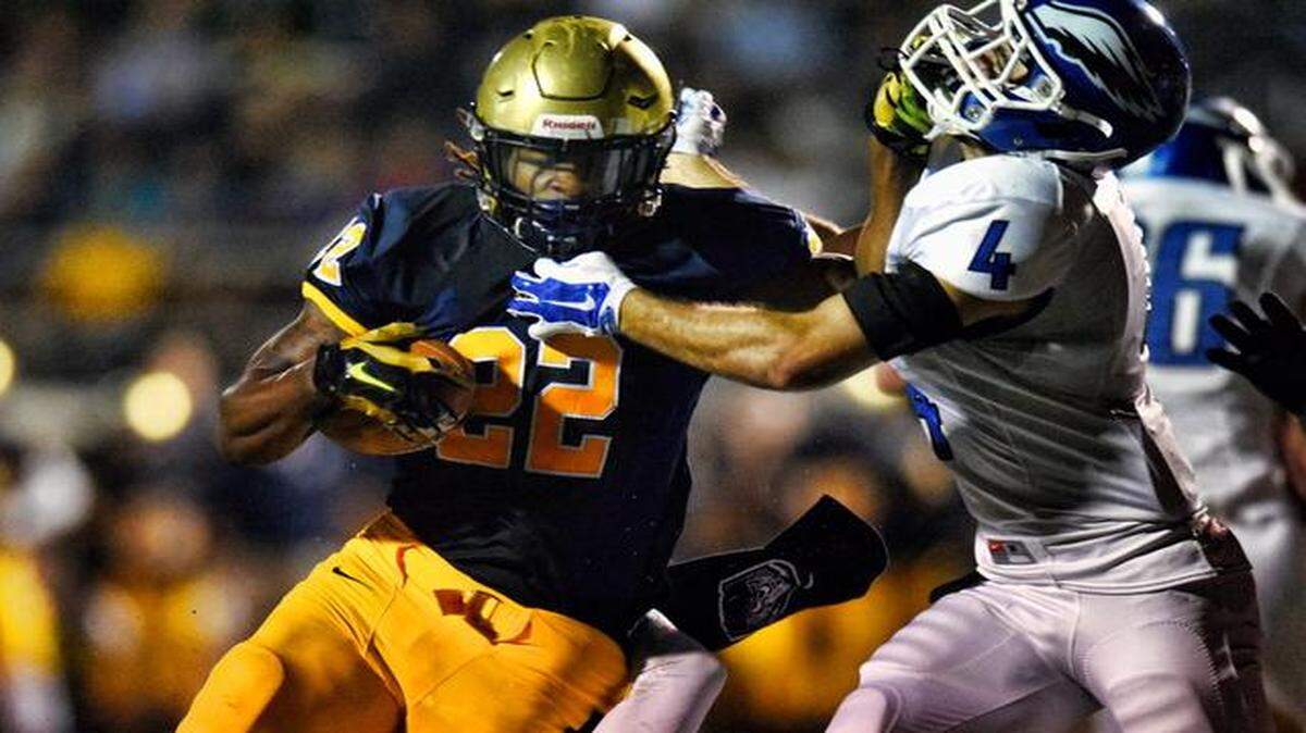 
Jordan Scarlett of St. Thomas scores a touchdown past Blake Duckworth of East Lake in the first quarter of their Class 7A state semifinal football game, Friday, Dec. 5, 2014.
