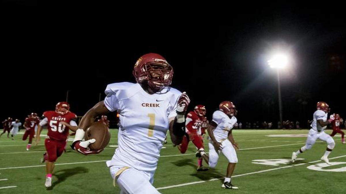 
Coconut Creek's Trayvon Mullen (1) returns a kickoff for a touchdown against Cardinal Gibbons in Fort Lauderdale on Friday, Oct. 10, 2014.
