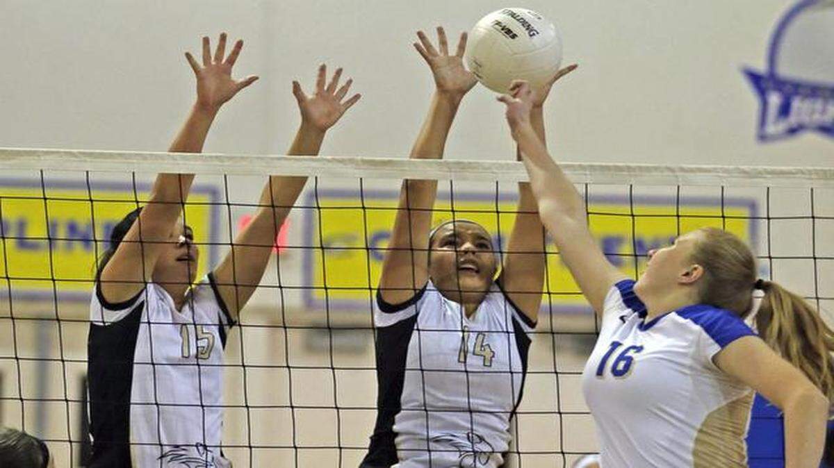 
Western volleyball players Nicole Carrillo and Kayla Francis attempt to block Cypress Bay’s Jordan Fron strike at Cypress Bay High School in Weston, Florida on Nov. 4, 2014.
