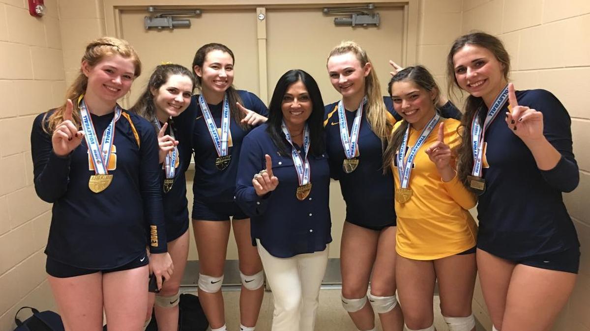 Members of the St. Thomas Aquinas girls’ volleyball team, with coach Lisa Zielinski in the middle following the team’s state-championship victory Saturday, from left: Derry Costigan, Kelsey O’Loughlin, Emma Dixon, Brook Bauer, Paula Cerame and Allison Marble.