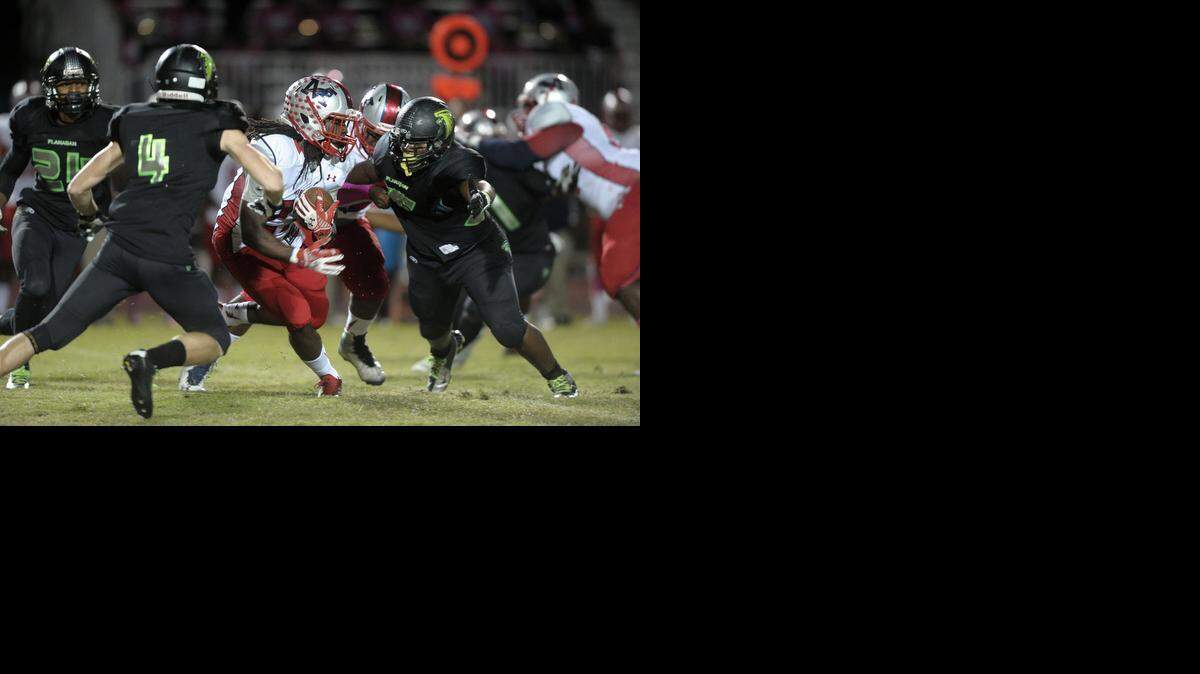 
Miramar running back Travonte Franklin gains a first down against the Flanagan defense during the first half, Friday, Oct. 17, 2014.
