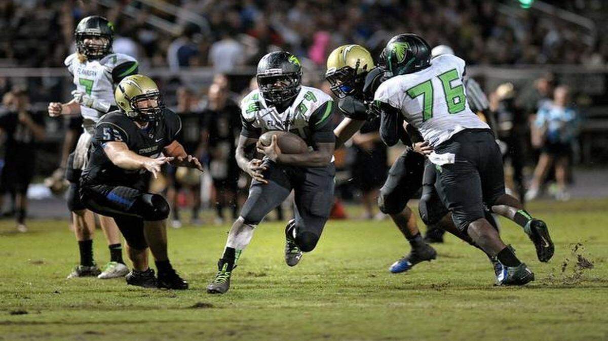 
Flanagan running back Arkeem Granger finds a hole in the Cypress Bay defense during the first half of their game, Friday, Sept. 19, 2014.
