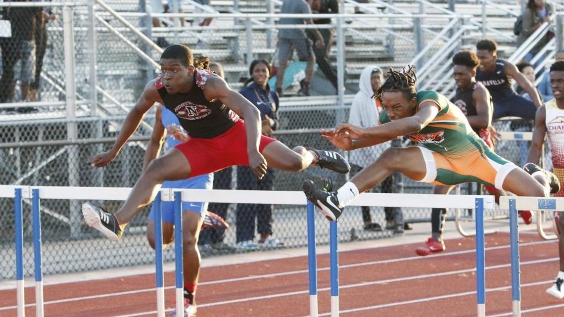 Northeast’s Wavell Hinds, left, wins the 110-meter hurdles during the 2018 BCAA Track and Field Championships finals on Friday at Dillard High in Fort Lauderdale.