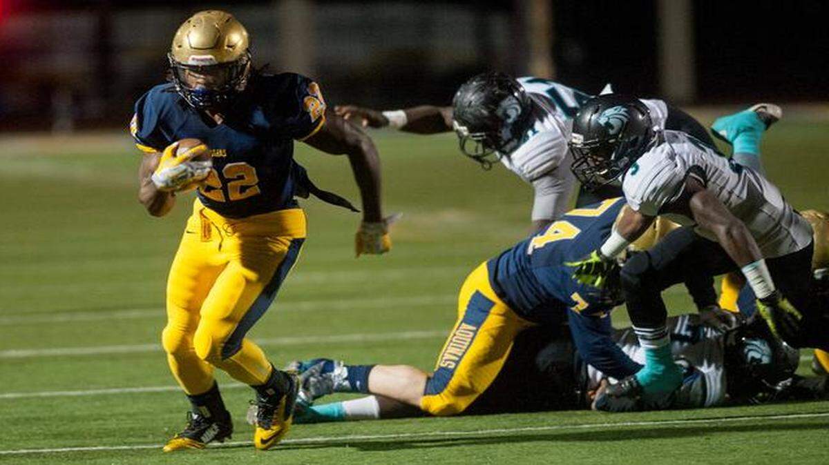 
St Thomas' Jordan Scarlett out runs the Royal Palm Beach defense for his first touchdown of the evening during their regional final game in Fort Lauderdale.
