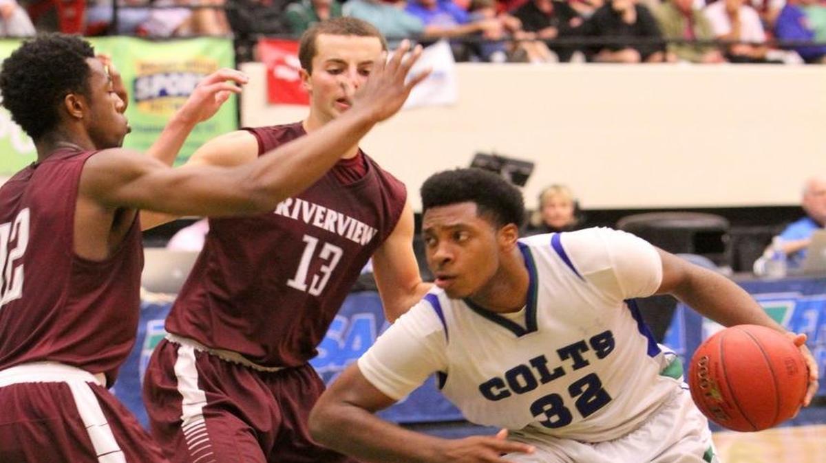 Coral Springs Myron Dewar tries to get to the basket as Riverview's Brion Whitley and Dominic Caldwell close in during the FHSAA 8A final Saturday February 27, 2016 in Lakeland, Florida. Coral Springs win the state title 61-57.