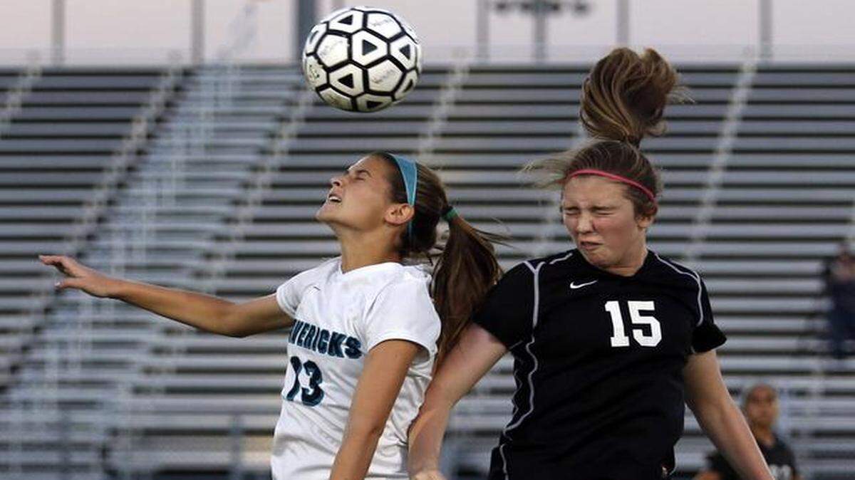 
Archbishop McCarthy’s Taylor Shore heads the ball as Katie Slattery defends during Cypress Bay’s 3-1 victory on Tuesday. 
