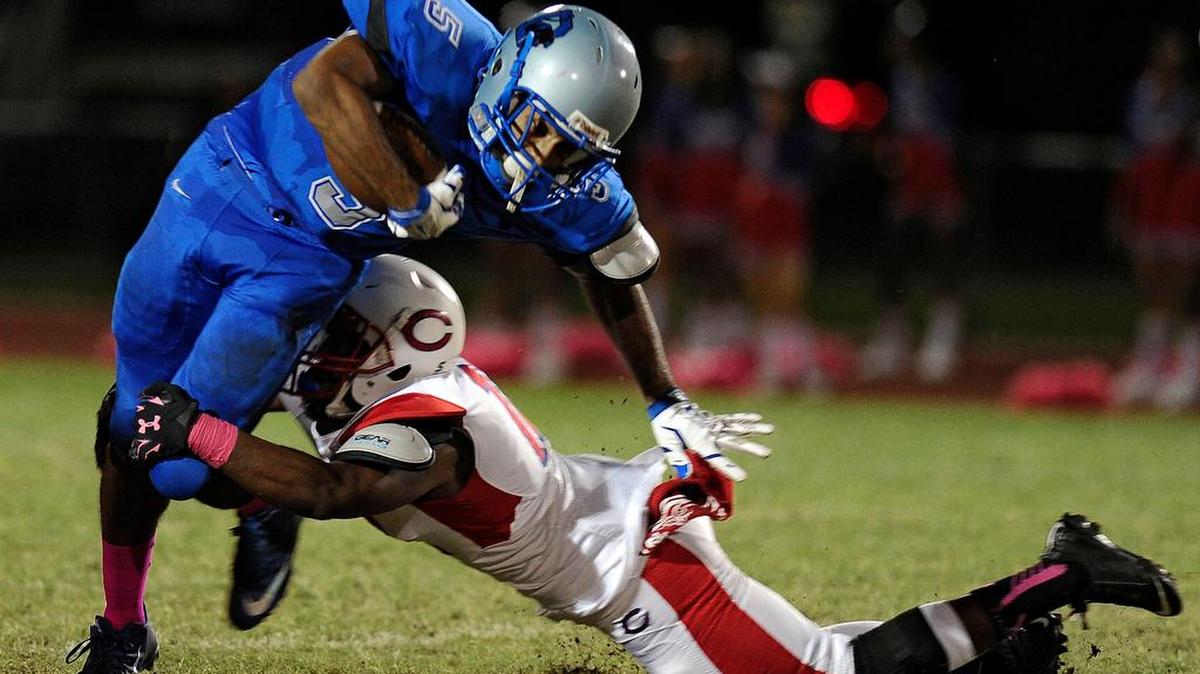 Dillard wide receiver Jordan Merrell tries to break a tackle attempt by Plantation’s Jerome Watson during the first half of Friday night’s game. Merrell caught 16 passes for 185 yards and two scores in the loss to the Colonels.