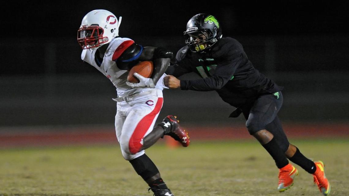 
Flanagan’s Quintin Bishop catches Plantation running back Jordan Johnson from behind during the second quarter of their game, Friday, October 9, 2015.
