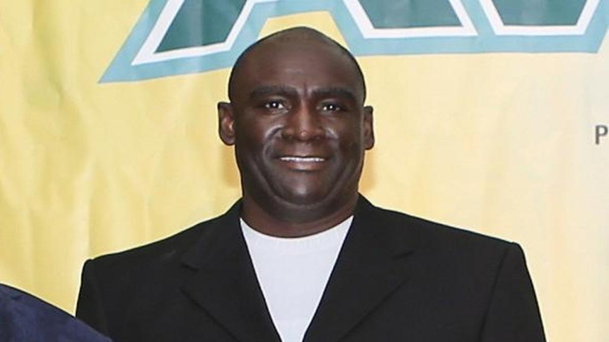 Blanche Ely basketball coach Melvin Randall, right, accepts the Boys’ Coach of the Year award from Miami Herald sportswriter George Richards during the Miami Herald’s annual All-Broward Athletic Awards breakfast presented by the Orange Bowl on Friday, May 22, 2015, at the Signature Grand in Davie.