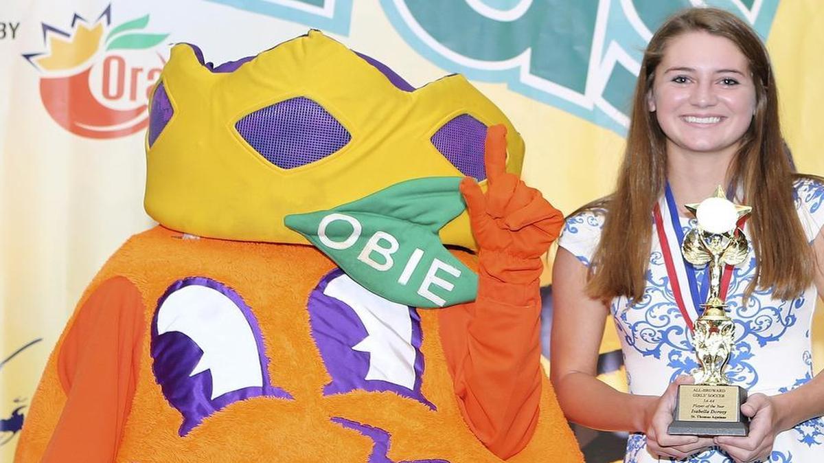 
Girls’ soccer 5A-4A Player of the Year Isabella Dorosy (St. Thomas Aquinas) stands with Obie during the Miami Herald’s annual All-Broward Athletic Awards breakfast presented by the Orange Bowl on Friday, May 22, 2015 at the Signature Grand in Davie.
