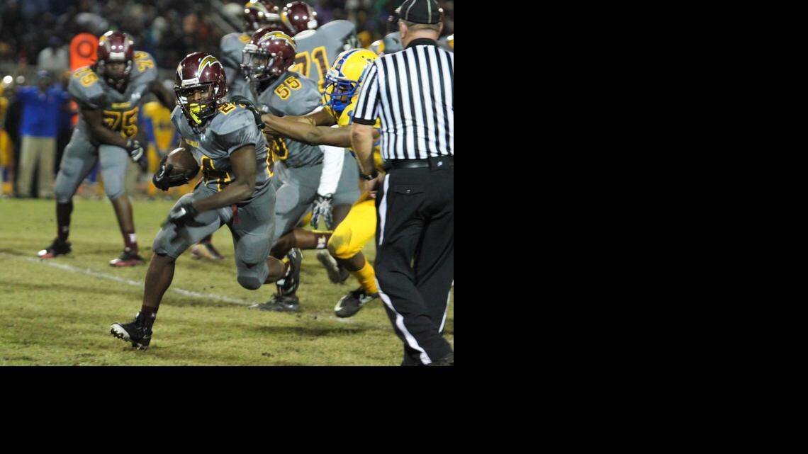 
Hallandale running back Jerone Lindo gains yards in the Chargers' 47-20 rout of Miami Northwestern on Friday night in the Region 4-6A quarterfinals. 
