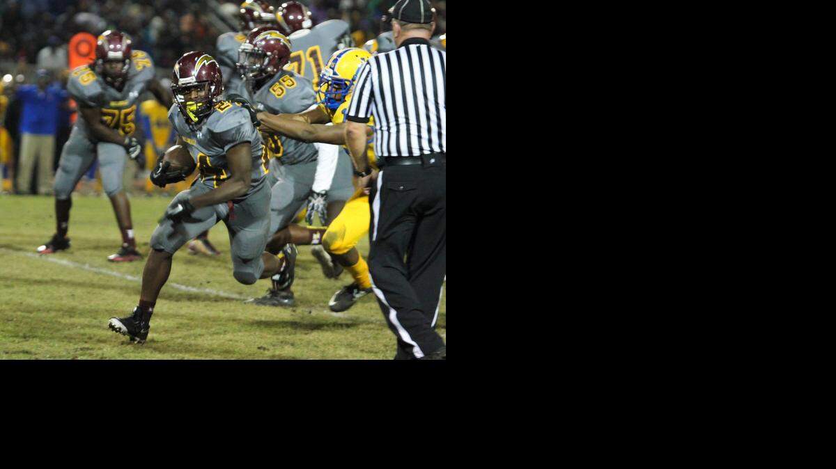
Hallandale running back Jerone Lindo gains yards in the Chargers' 47-20 rout of Miami Northwestern on Friday night in the Region 4-6A quarterfinals. 
