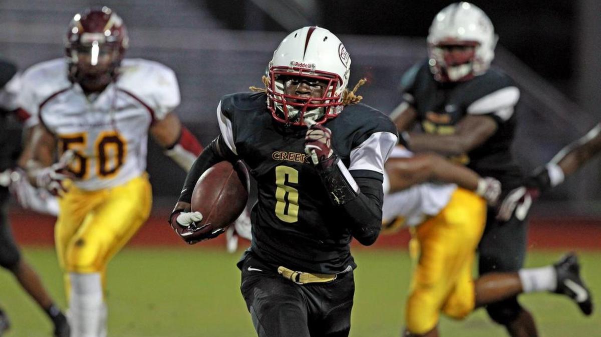 
Coconut Creek’s Malek Young breaks away from the Hallandale defense to score a touchdown during last season’s matchup.
