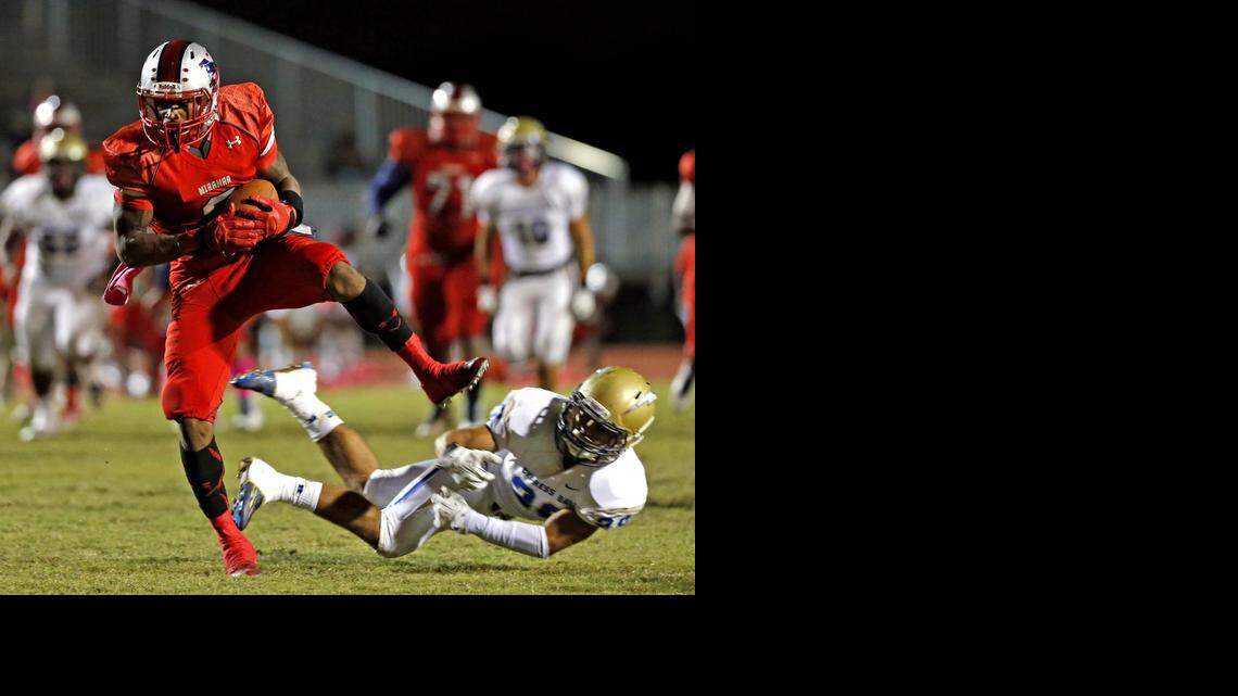 
Miramar receiver Khalil Lewis scores a touchdown in the second quarter after breaking loose from Cypress Bay’s Danny Montoya at Miramar High School, Oct. 24, 2014.
