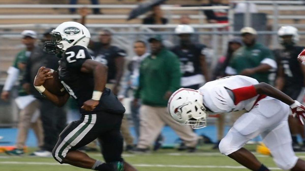 Central running back Lexington Joseph, left, slips by Chaminade's defense for a touchdown during first half action of the Central vs Chaminade opener at Traz Powell Stadium.